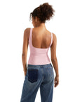 Pink backless tank top with wide straps paired with blue jeans, ideal for casual or activewear.