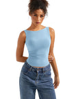 Light blue sleeveless women's top paired with high-waisted jeans, perfect for casual or activewear outfits.