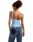 Light blue backless tank top with wide straps, paired with high-waisted jeans for casual women's fashion