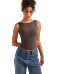 Brown sleeveless fitted top with high-waisted blue jeans, women's fashion outfit