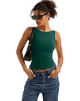 Woman in green sleeveless crop top and high-waisted jeans, stylish summer outfit