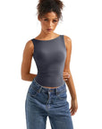 Women's dark gray sleeveless crop top paired with high-waisted blue jeans, stylish activewear outfit