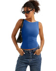 Woman in blue sleeveless crop top and high-waisted jeans, stylish casual outfit