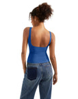 Blue backless tank top with wide straps, paired with high-waisted jeans for casual women's fashion