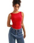Red sleeveless women's top with wide neckline paired with high-waisted jeans