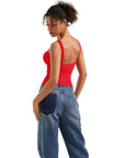 Woman in red backless tank top and wide-leg jeans, stylish women's clothing