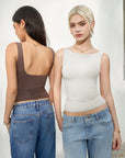 Women modeling stylish sleeveless tops with ruched sides, paired with denim jeans for casual wear.