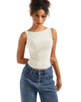 Cream sleeveless crop top with high-waisted blue jeans, women's fashion